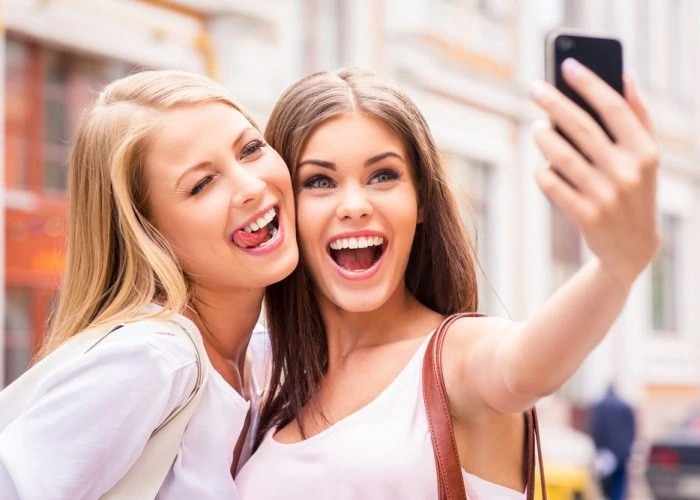 two girls takes selfie